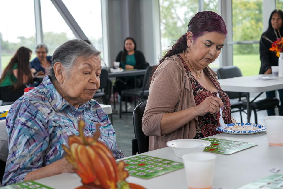 JoAnn Rogerio, right, and her grandmother Lorenza Carreño, left, eat at the Nov. 16 Meals on Wheels event. Rogerio says the time it takes to reach her preferred H-E-B means that she and her family try to make the grocery trip only once every two to three weeks.