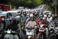 Motorists are stuck in the morning rush hour traffic in Jakarta, Indonesia, Wednesday, Jan. 26, 2022. Indonesian parliament last week passed the state capital bill into law, giving green light to President Joko Widodo to start a $34 billion construction project this year to move the country's capital from the traffic-clogged, polluted and rapidly sinking Jakarta on the main island of Java to jungle-clad Borneo island amid public skepticism. (AP Photo/Dita Alangkara)