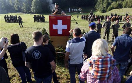 Family members and friends of recruits from the veterinary troops attend an official visiting day at a Swiss army base in Sand bei Schoehnbuehl, outside Bern September 7, 2013. REUTERS/Ruben Sprich