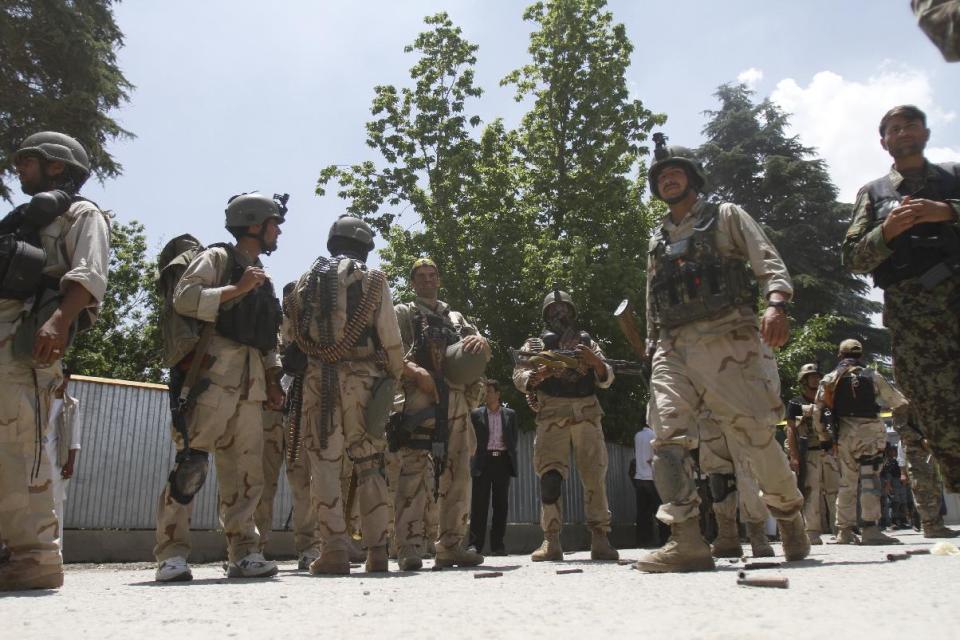 Afghan special forces are seen outside the Spozhmai hotel at Lake Qargha where security officials say Taliban insurgents have killed at least 17 people, most of them civilians, in an attack that began before midnight on Thursday, just north of Kabul, Afghanistan, Friday, June, 22, 2012. It was the latest in a string of attacks this week that suggest the insurgent group is pushing hard with its summer offensive rather than waiting for international forces to draw down. (AP Photo/Ahmad Jamshid)