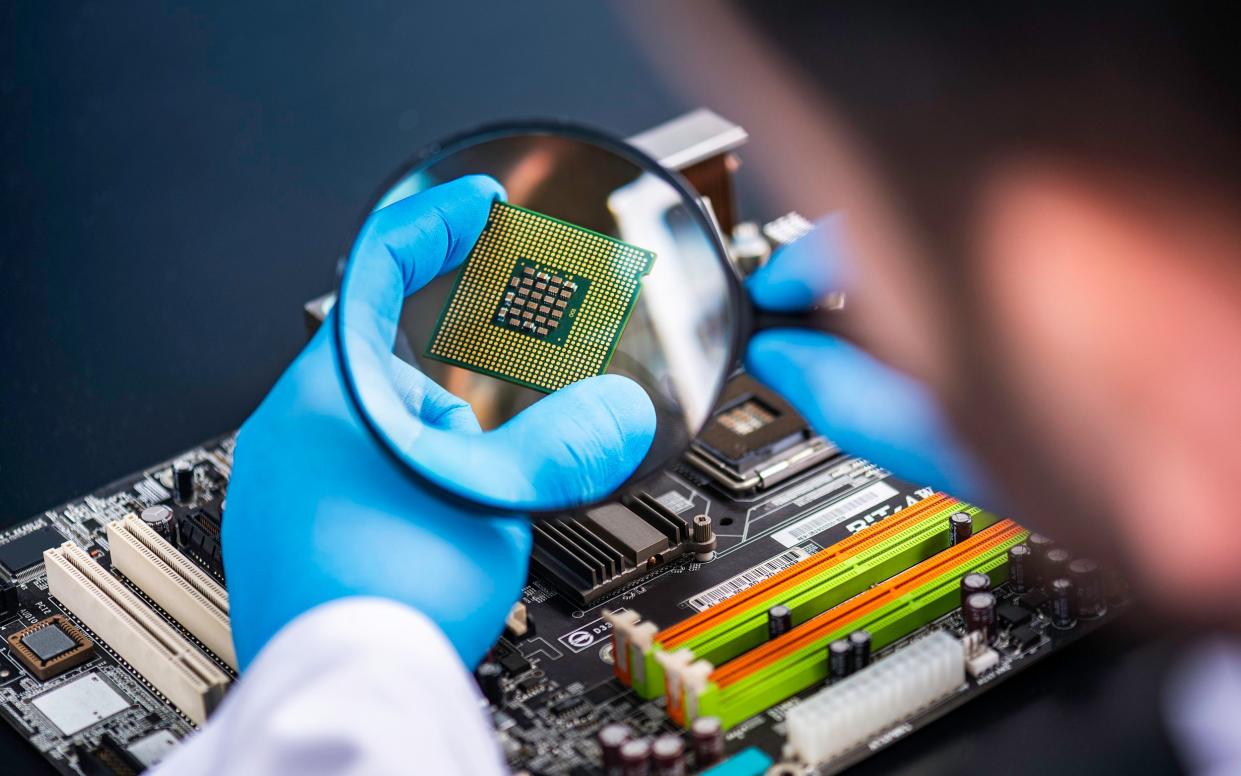 Technician looking at a computer chip