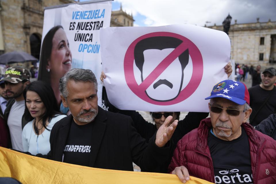 Supporters of opposition leader María Corina Machado sing their national anthem during a protest demanding free and fair elections in Venezuela's upcoming election, in Bolivar Square in Bogota, Colombia, Saturday, April 6, 2024. (AP Photo/Fernando Vergara)