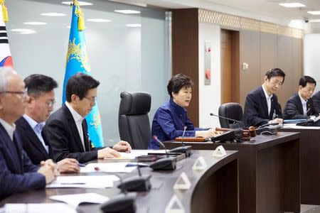 South Korean President Park Geun-hye (3rd R) presides over the National Security Council at the Presidential Blue House in Seoul, South Korea, in this handout picture provided by the Presidential Blue House and released by Yonhap on February 7, 2016. REUTERS/Presidential Blue House/Yonhap