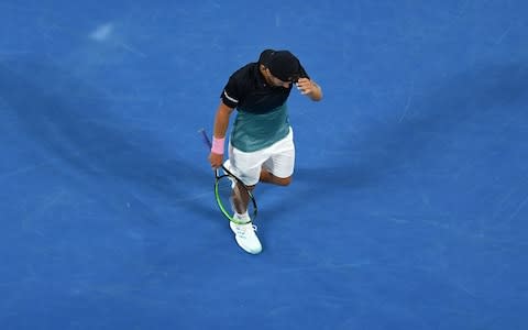 France's Lucas Pouille walks on the court as he plays against Serbia's Novak Djokovic during their men's singles semi-final match on day 12 of the Australian Open tennis tournament in Melbourne on January 25, 2019. - Credit: AFP