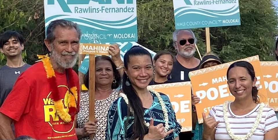 Walter Ritte and Maui County Councilmember Keani Rawlins-Fernandez stand in a group on the island of Molokai.