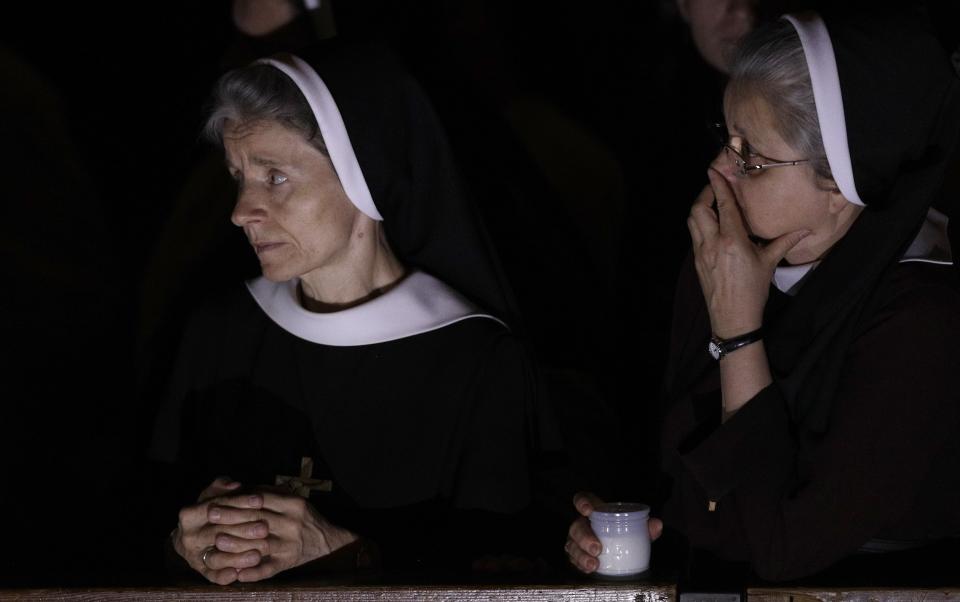 Nuns follow a solemn Easter vigil ceremony celebrated by Pope Francis, in St. Peter's Basilica at the Vatican, Saturday, April 15, 2017. (AP Photo/Andrew Medichini)