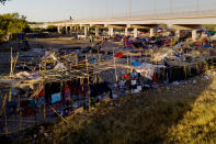 Migrants, many from Haiti, are seen in an encampment near the Del Rio International Bridge, Friday, Sept. 24, 2021, in Del Rio, Texas. (AP Photo/Julio Cortez)