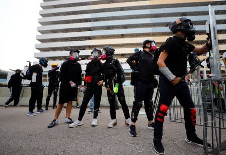 Demonstrators stand behind barricades during a protest in Hong Kong