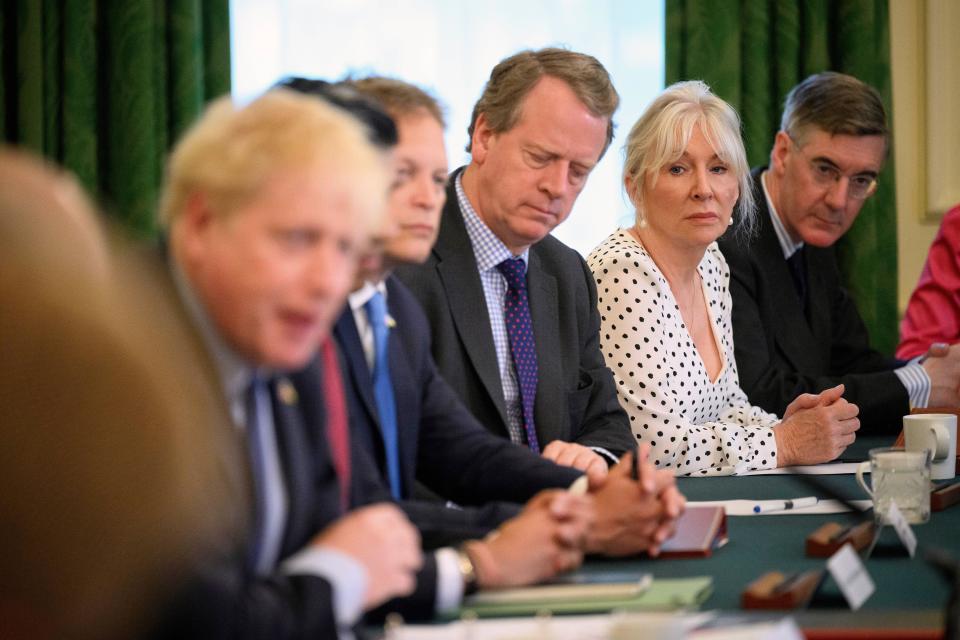 Britain's Culture Secretary Nadine Dorries, second from right, listens as Britain's Prime Minister Boris Johnson, left, addresses his Cabinet during his weekly Cabinet meeting in Downing Street on Tuesday, June 7, 2022 in London. Johnson was meeting his Cabinet and trying to patch up his tattered authority on Tuesday after surviving a no-confidence vote that has left him a severely weakened leader. (Leon Neal/Pool Photo via AP)