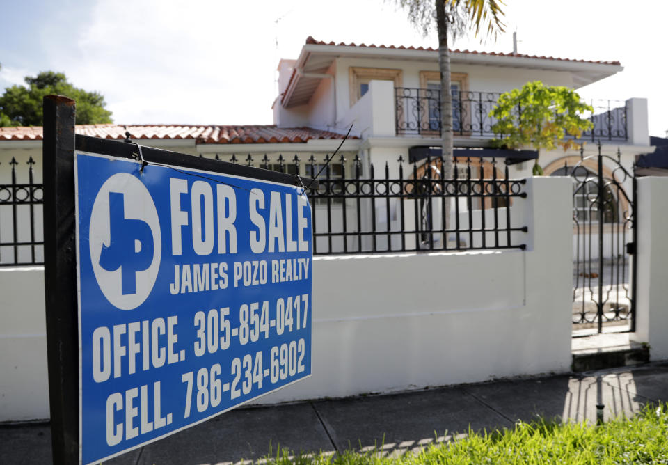In this Friday, July 19, 2019 photo, a For Sale sign is posted in front of a home in Miami. On Thursday, July 25, Freddie Mac reports on this week’s average U.S. mortgage rates. (AP Photo/Lynne Sladky)