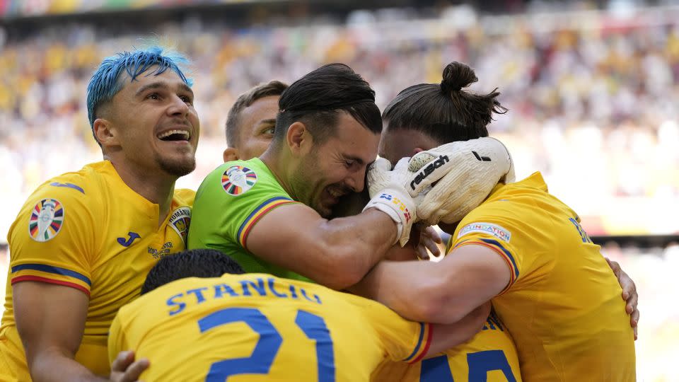 Romania's players celebrate during their victory against Ukraine on Monday. - Antonio Calanni/AP
