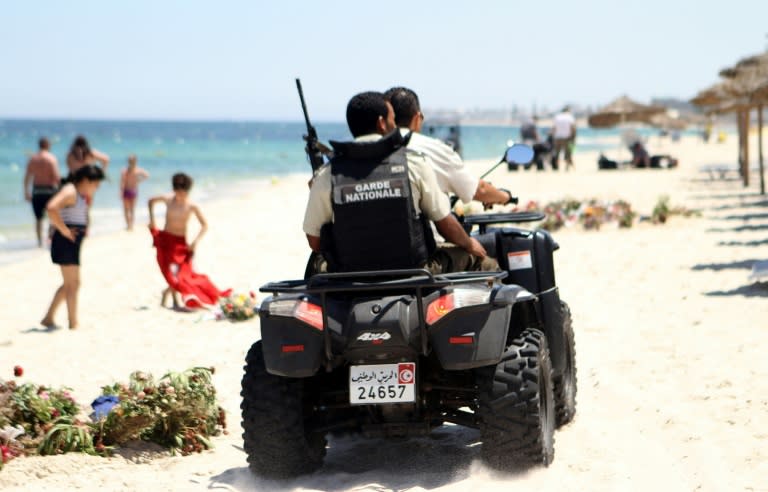 Tunisian security forces patrol a beach in Sousse, south of the capital Tunis, on July 1, 2015, as Tunisia started deploying armed police around tourist sites following last week's massacre in Port El Kantaoui by a jihadists gunman. Tunisian authorities vowed new heightened security measures, including 1,000 armed officers to reinforce tourism police -- who will be armed for the first time -- at hotels, beaches and other attractions. AFP PHOTO / BECHIR TAIEB