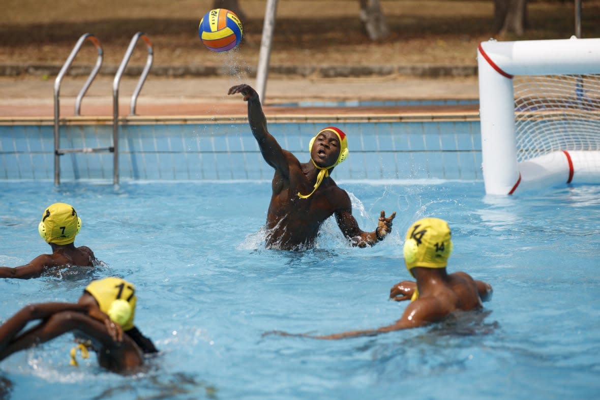 Young people play water polo at the University of Ghana in Accra, Saturday, Jan. 14, 2023. Former water polo pro Asante Prince is training young players in the sport in his father’s homeland of Ghana, where swimming pools are rare and the ocean is seen as dangerous. (AP Photo/Misper Apawu)