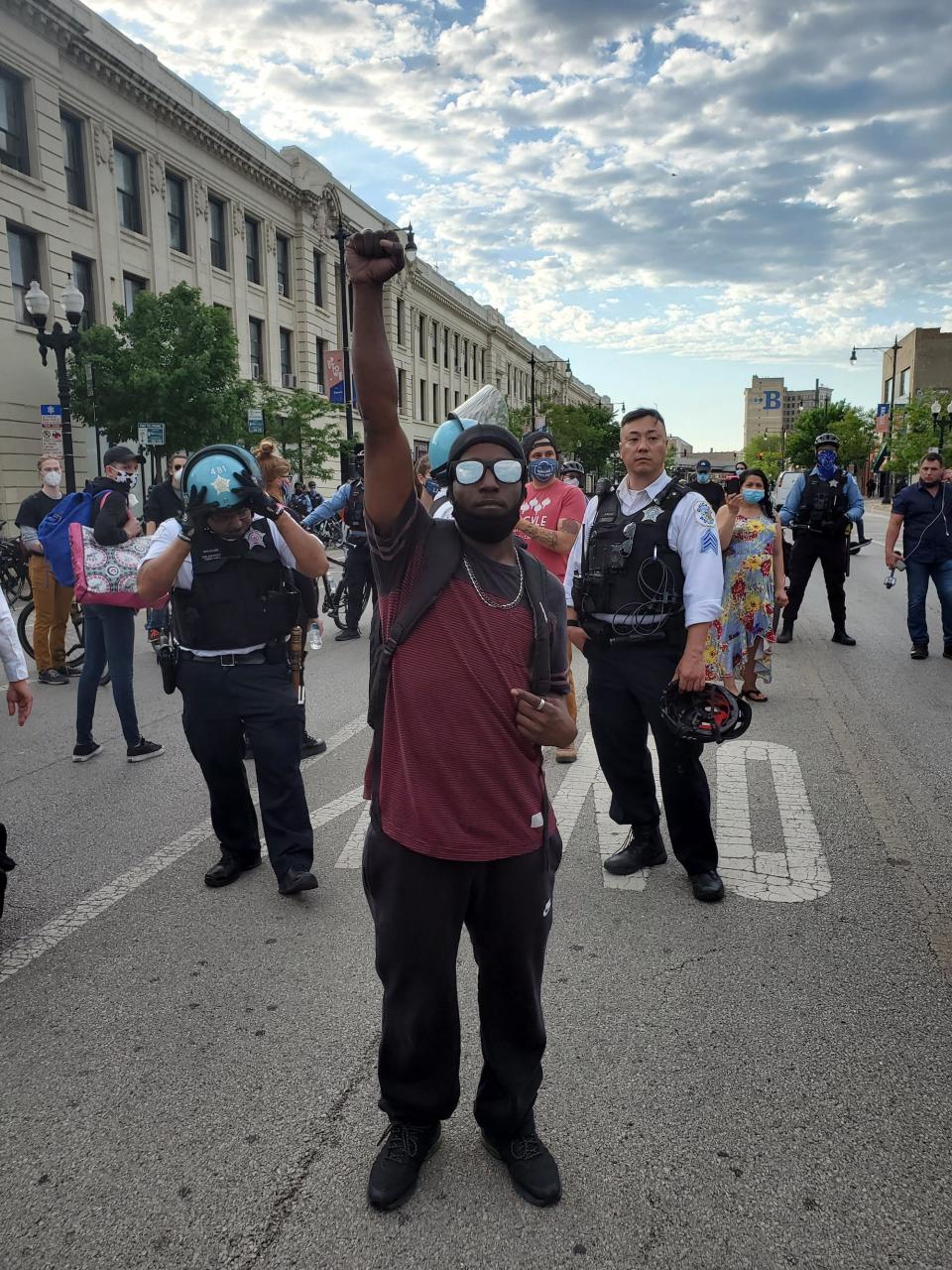 Cam O'Kelly stands in front of police officers in Chicago's Uptown neighborhood on June 1, 2020.