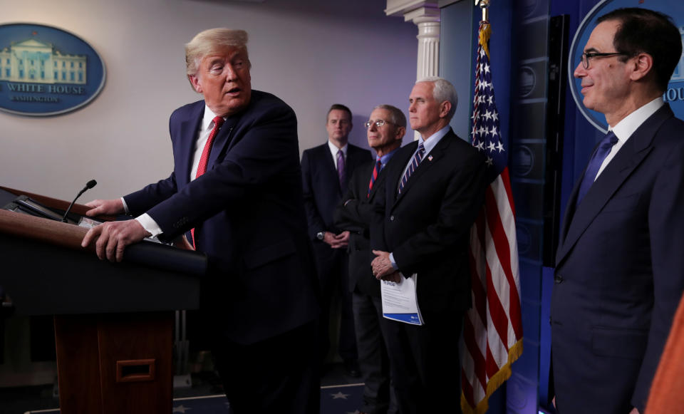 U.S. President Donald Trump looks back at U.S. Treasury Secretary Steven Mnuchin as the president addresses the coronavirus task force daily briefing with Dr. Anthony Fauci, Vice President Mike Pence and Mnuchin at the White House in Washington, U.S., March 25, 2020. REUTERS/Jonathan Ernst