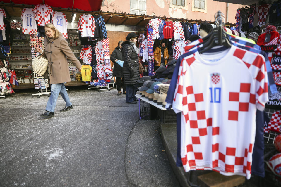 People walk among shops selling Croatian football jerseys and various fan props prior to the Qatar World Cup semi-final match between Croatia and Argentina, in Zagreb, Croatia, Tuesday, Dec. 13, 2022. (AP Photo/Armin Durgut)