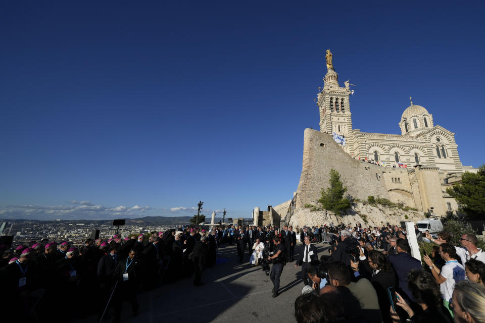 Pope Francis passes in front of the Notre Dame de la Garde Basilica as he reaches the Memorial dedicated to sailors and migrants lost at sea for a moment of reflection with religious leaders, in Marseille, France, Friday, Sept. 22, 2023. Francis, during a two-day visit, will join Catholic bishops from the Mediterranean region on discussions that will largely focus on migration. (AP Photo/Pavel Golovkin)