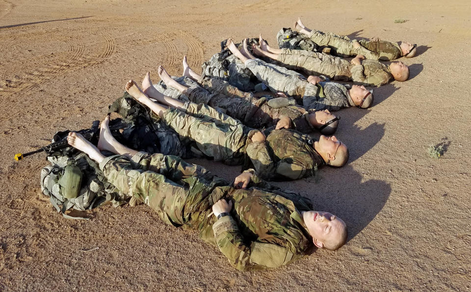 Candidates from the Air Force Security Forces Center Ranger Assessment Course 16-1 take a well-earned nap after successfully completing a 12-mile ruck march in less than 3 hours on April 22, 2016.