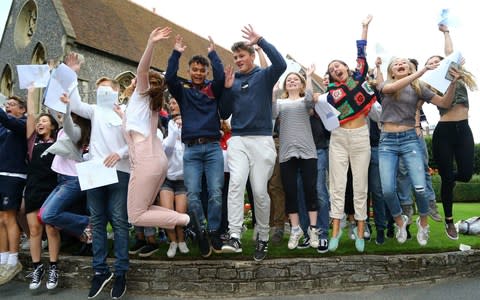 Students at Brighton College celebrate after opening their exam results - Credit: Gareth Fuller /PA