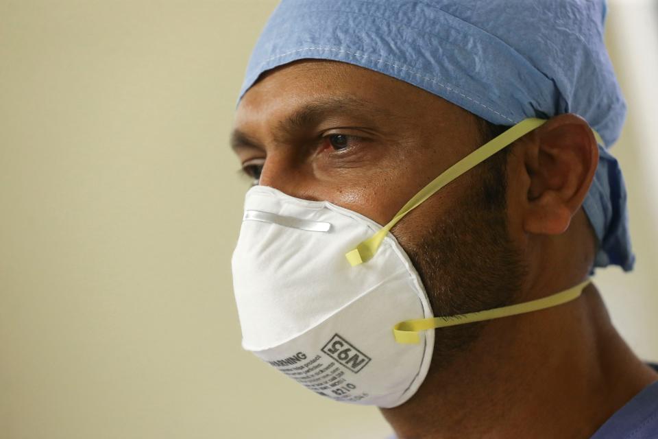 Dr. Ramesh Peramsetty wears an N95 mask at his First Care clinic on Tuesday, March 31, 2020. Dr. Peramsetty and his team have been testing for the COVID-19 virus since before DCH began testing. (Press photo/Gary Cosby Jr.) 