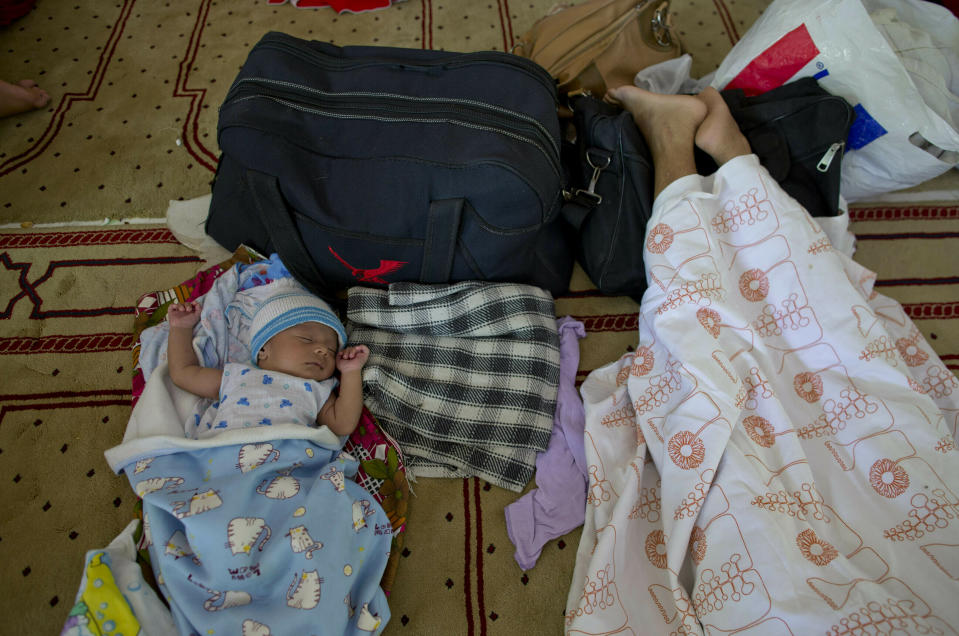 FILE - In this Thursday, April 25, 2019 file photo, ten-day-old Ahmadi Muslim infant Amdad Ahamed sleeps at a community center, where his family has taken refuge in for fear of retaliation towards their community after the Easter Sunday bombings, in Pasyala, north east of Colombo, Sri Lanka. Roughly 250 people died in six coordinated suicide bombings that ripped through Sri Lanka on Easter Sunday. (AP Photo/Gemunu Amarasinghe, File)