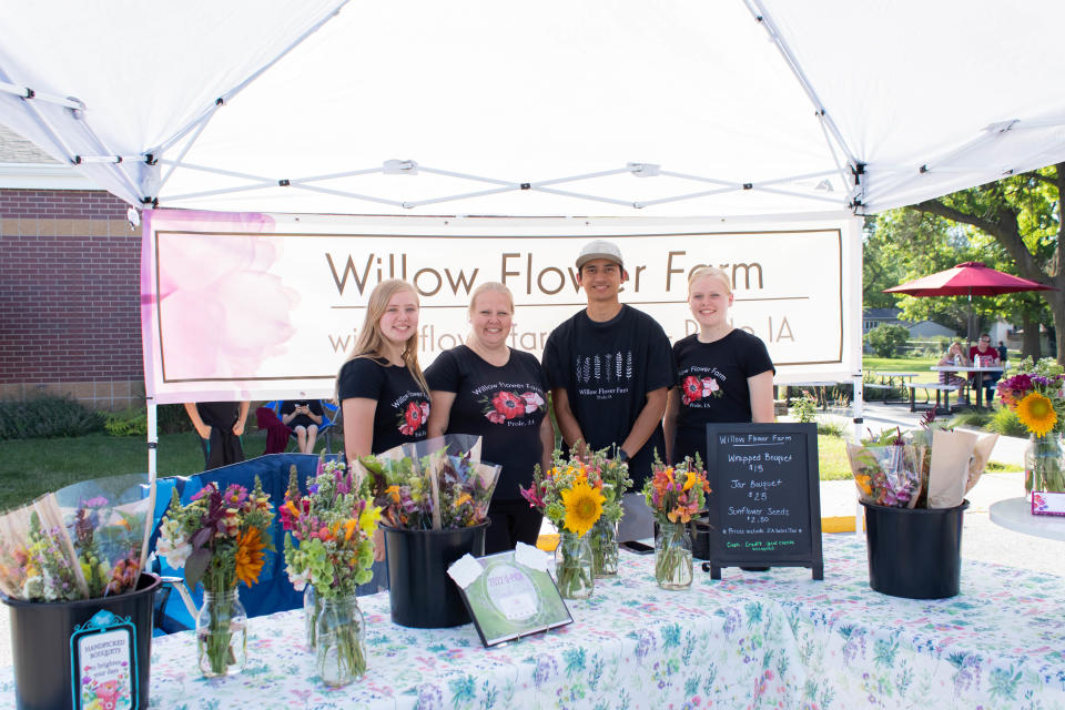 From left, Natalie Septer, 14, Mandy Septer, Tucker Septer, 17, and Valerie Septer, 16, with Willow Flower Farm pose for a photo during the Grimes Farmers Market on Friday, July 1, 2022.