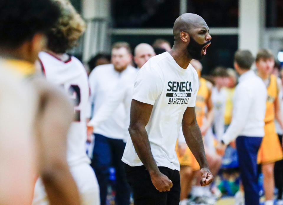 Seneca coach Leroy Hickerson yells in excitement as his team takes a big lead against seventh-ranked St. Xavier on Friday night.