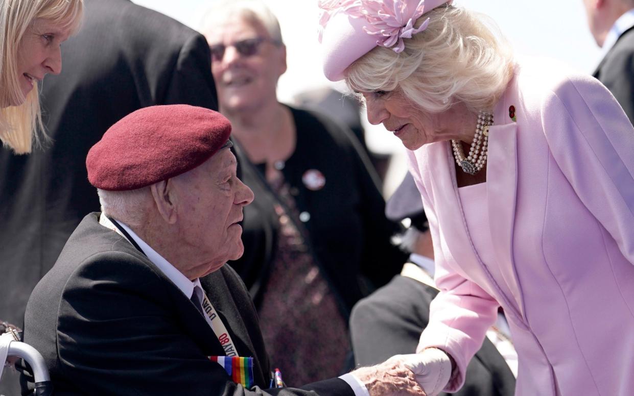 Queen Camilla pauses to shake hands with the same veteran