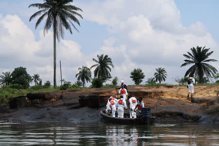 A team of the joint task force, part of the Bodo oil spill clean-up operation, disembarks from a boat at the site of an illegal refinery near the village of Bodo in the Niger Delta, Nigeria August 2, 2018. REUTERS/Ron Bousso