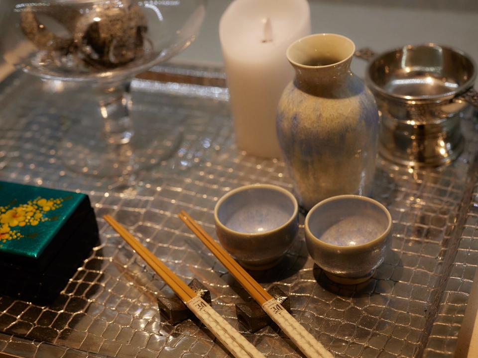 A tabletop with candles and incense sticks.