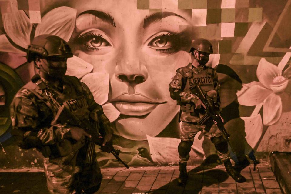 Soldiers patrol during a night curfew imposed at the Comuna 13 neighborhood, in Medellin, Colombia on October 30, 2020 amid the COVID-19 coronavirus pandemic. - Authorities placed the department Antioquia and its capital Medellin under a new lockdown after an increase in coronavirus cases. (Photo by JOAQUIN SARMIENTO / AFP) (Photo by JOAQUIN SARMIENTO/AFP via Getty Images)