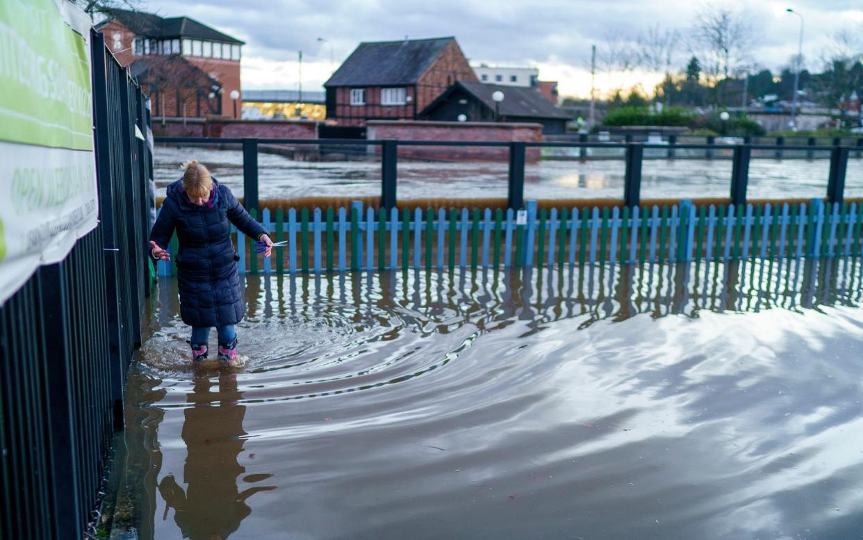 A woman walks through floodwater in Northwich town centre on Thursday - Christopher Furlong /Getty Images Europe 