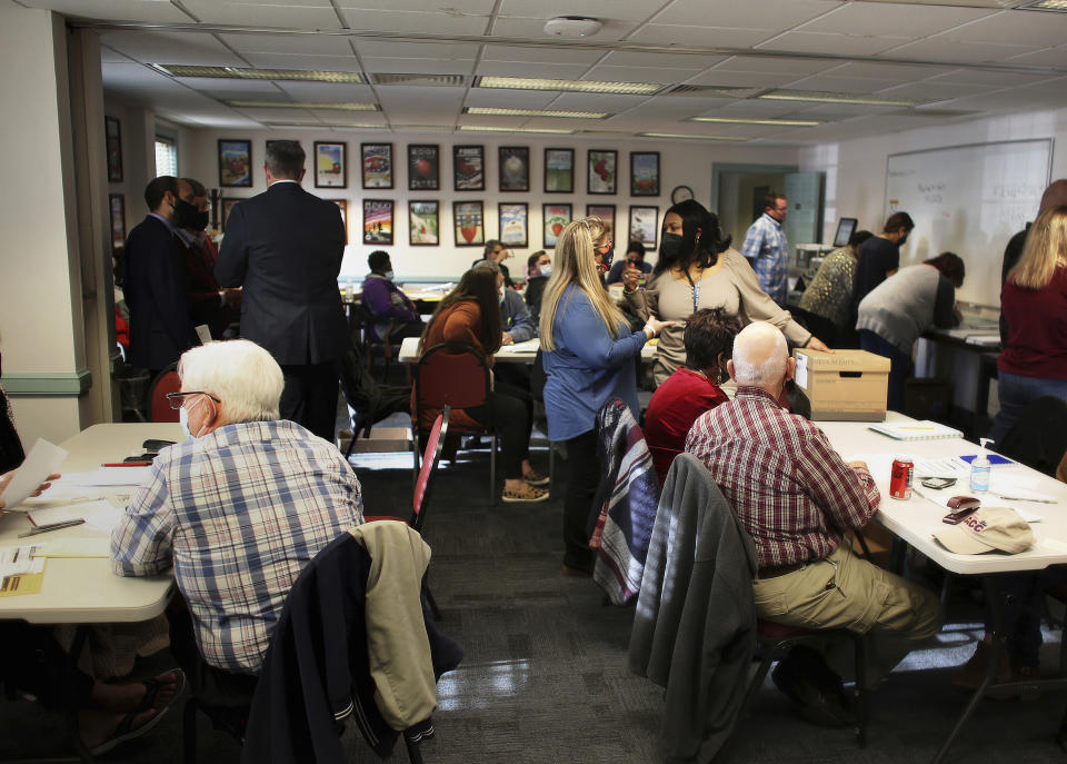 Election officials begin the process of recounting one of two unresolved races that will settle whether Virginia Republicans have reclaimed the majority in the House of Delegates, Thursday, Dec. 2, 2021 in Virginia Beach, Va. (Stephen M. Katz/The Virginian-Pilot via AP)