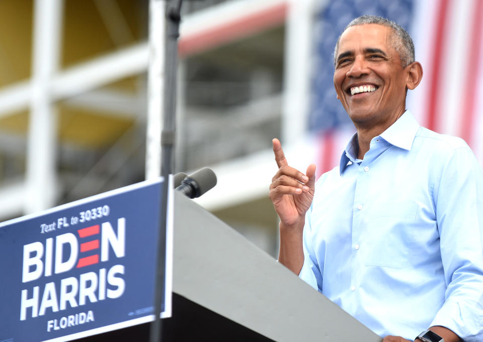 A smiling Barack Obama pictured on stage at Florida campaign event.