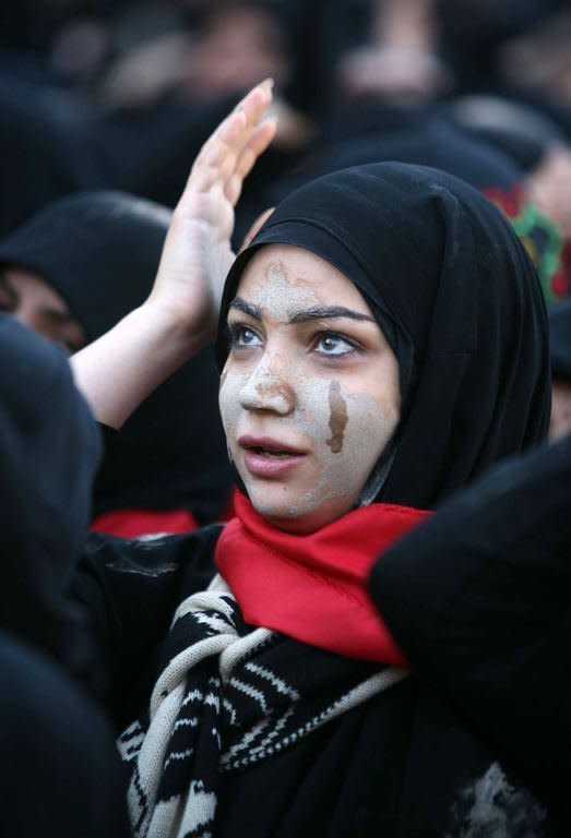 A Shiite Muslim woman attends the Arbaeen religious festival in the shrine city of Karbala, southwest of Iraq's capital Baghdad, on January 3, 2013 to mark the 40th day after Ashura. The seventh century battle near Karbala is at the heart of the historical division between Islam's Sunni and Shiite sects