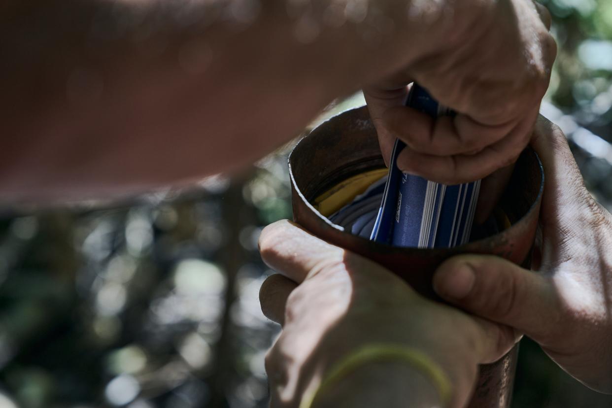 A Ukrainian soldier loads flyers urging the Russian soldiers to surrender, into a Grad multiple launch rocket system (AP)