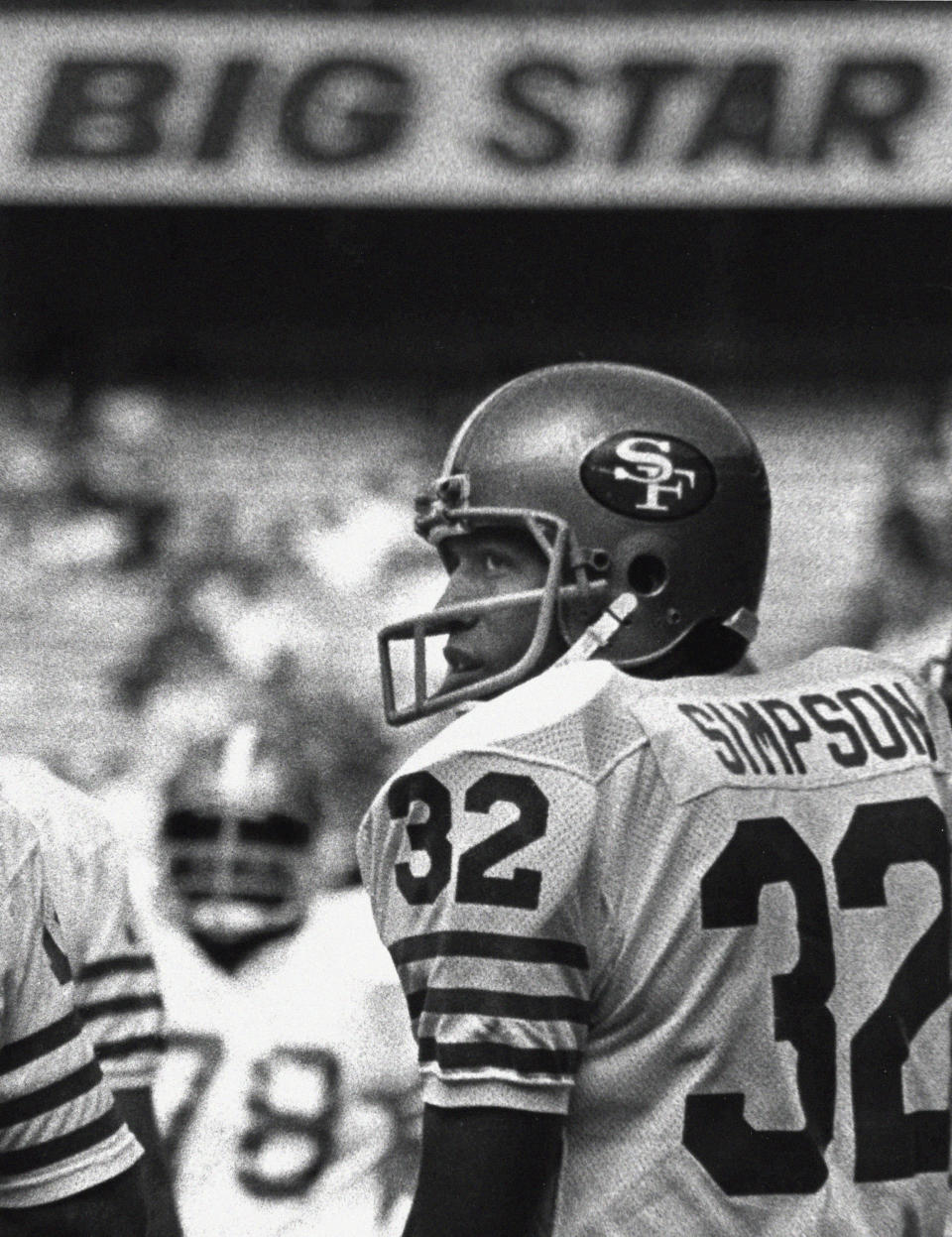 FILE - San Francisco 49ers running back O.J. Simpson looks over his shoulder at fans in the stands calling for his attention before an NFL football game against the Atlanta Falcons game in Atlanta, Sunday, Dec. 16 1979. O.J. Simpson, the decorated football superstar and Hollywood actor who was acquitted of charges he killed his former wife and her friend but later found liable in a separate civil trial, has died. He was 76. (AP Photo/Charles Kelly, File)