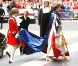 <p>The queen wore a detailed dress, tiara, and a red and blue cape–while a royal page carried the train–when she arrived for a church service at Saint Paul's Cathedral in London.</p>