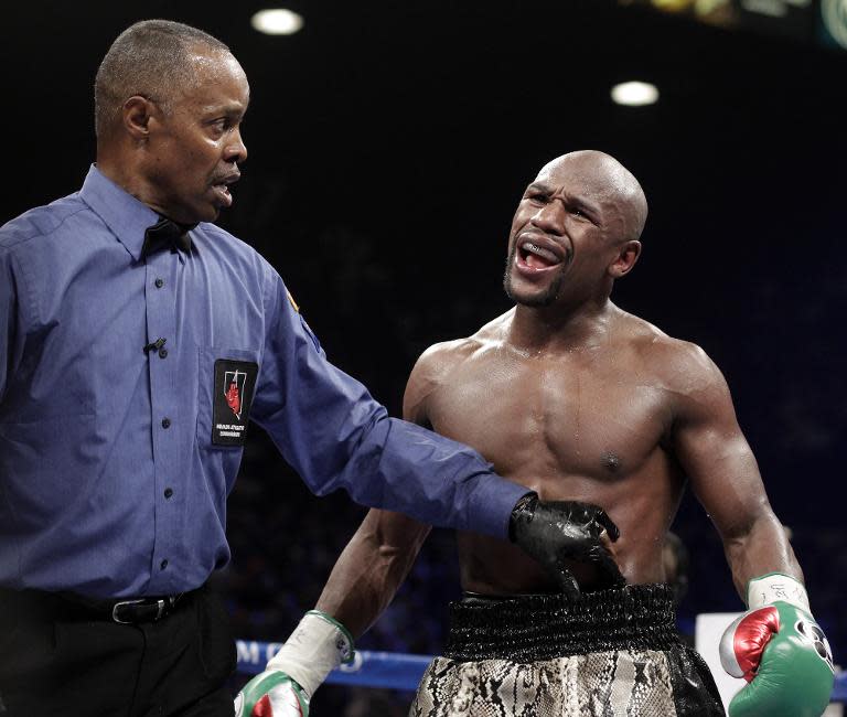 Referee Kenny Bayless holds back Floyd Mayweather during his boxing bout against Marcos Maidana on September 13, 2014 at The MGM Grand