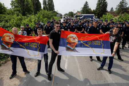 Supporters of Serbian Radical Party leader Vojislav Seselj hold banners during a protest in the village of Jarak, near Hrtkovci, Serbia, May 6, 2018. REUTERS/Marko Djurica