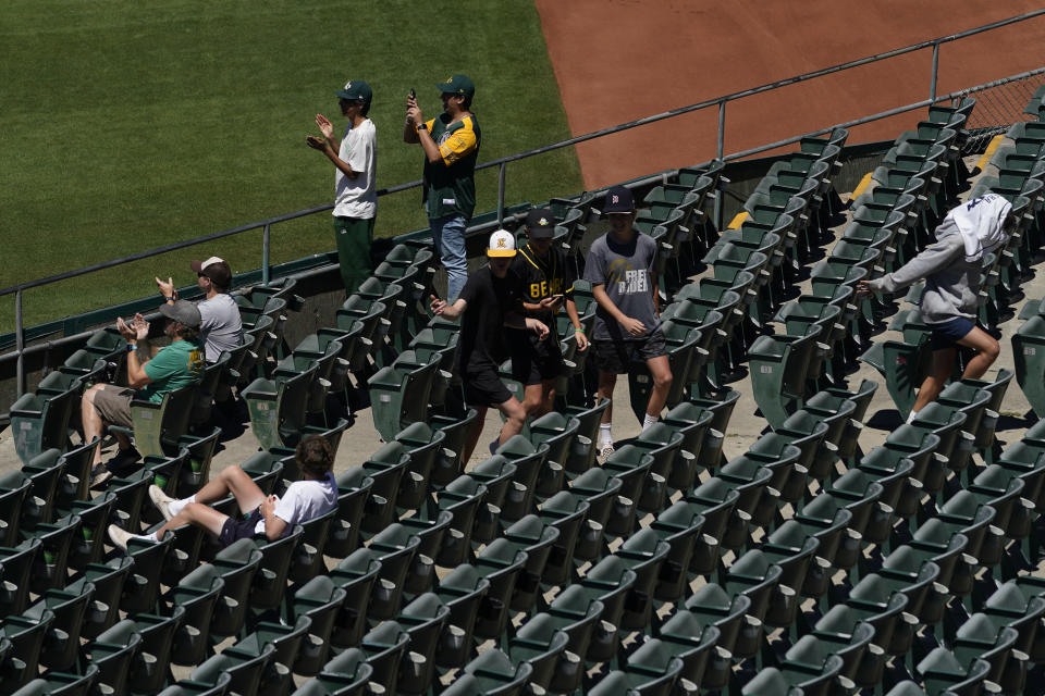 Fans attend the first baseball game of a doubleheader between the Oakland Athletics and the Detroit Tigers in Oakland, Calif., Thursday, July 21, 2022. (AP Photo/Godofredo A. Vásquez)