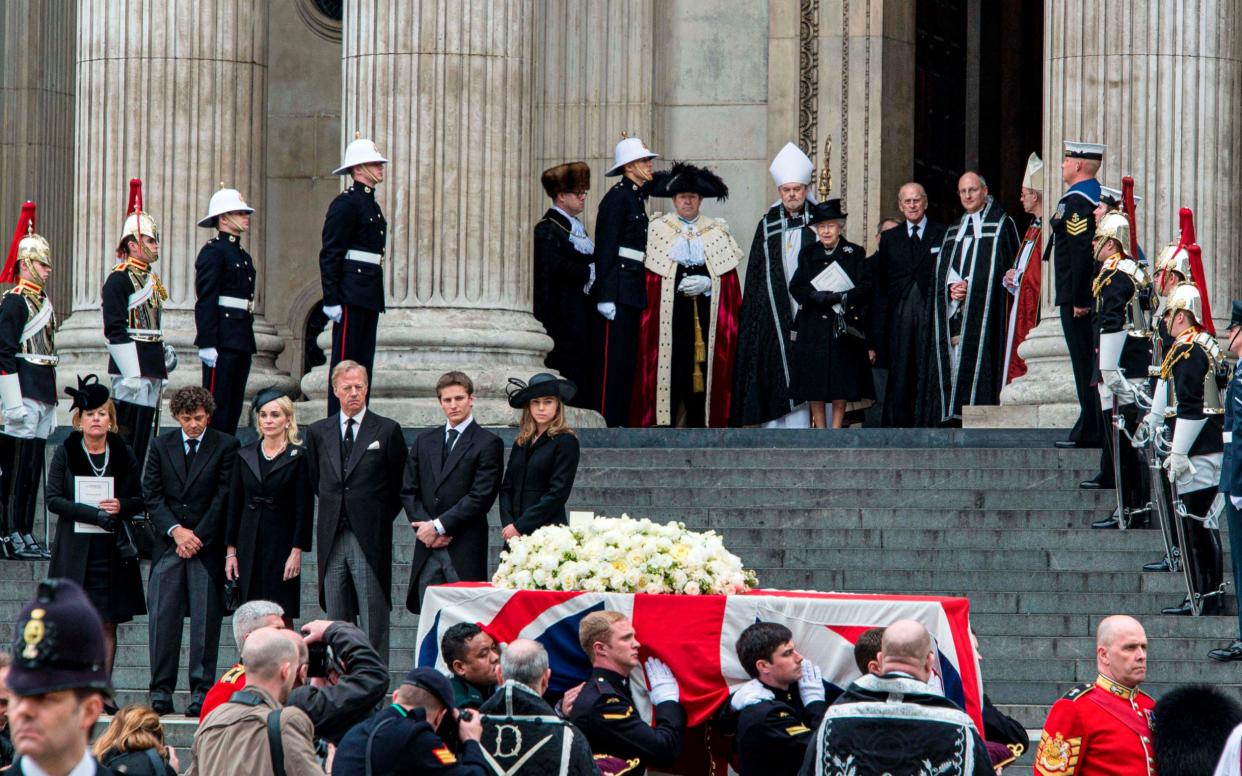 Michael Thatcher stands alongside his father during his grandmother's funeral - Shutterstock