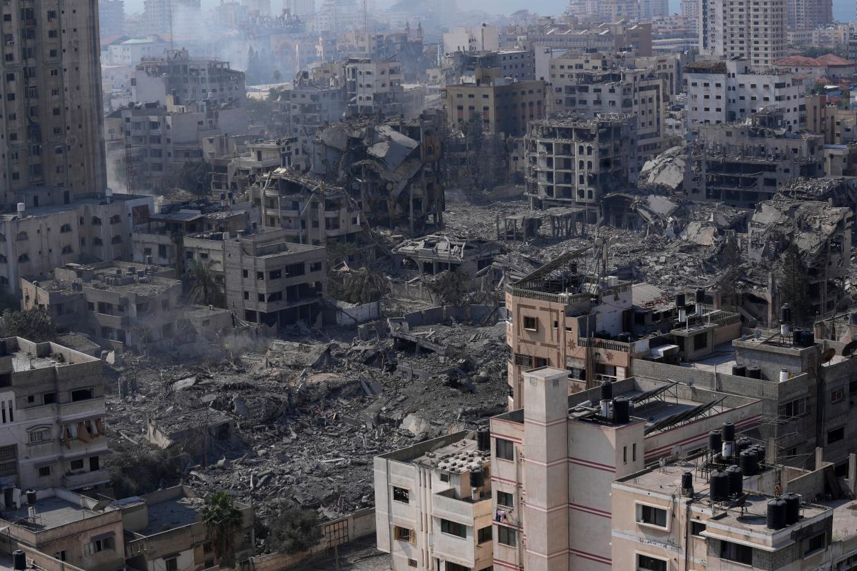 Destruction from Israeli aerial bombardment is seen in Gaza City, Wednesday, Oct. 11, 2023. (AP Photo/Adel Hana)