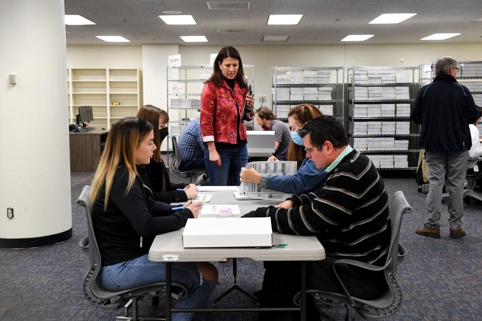 Christi Hill, of the Ventura County Elections Division, supervises as Allison Blackburn (left) Katelyn Fiers, Susan Campbell-Phaneuf and Brett Hanley participate in a recount of the Ojai mayor's race at the Ventura County Government Center on Monday, Dec. 19, 2022 after only 42 votes separated incumbent Betsy Stix from Anson Williams.
