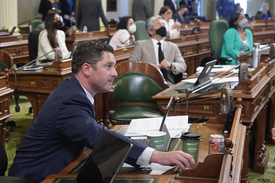 Assemblyman Jordon Cunningham, R-San Luis Obispo, presses the yes button as he votes for his social media bill during the Assembly session at the Capitol in Sacramento, Calif., on Monday, May 23, 2022. The Assembly approved Cunningham's measure that would hold social media companies responsible for harming children who have become addicted to their products. It would let parents sue platforms like Instagram and TikTok for up to $25,000 per violation. (AP Photo/Rich Pedroncelli)