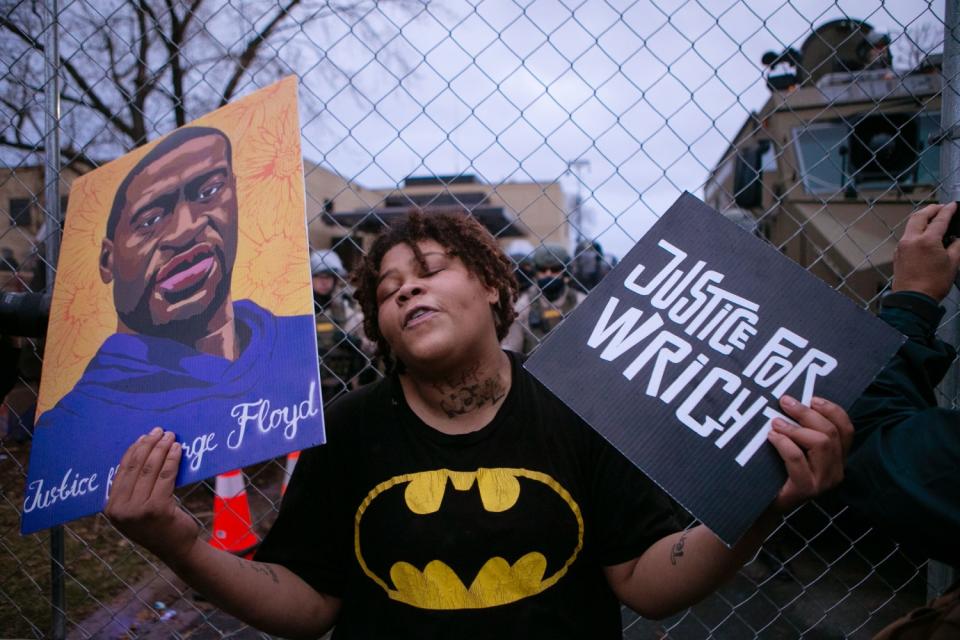 A demonstrator holds signs