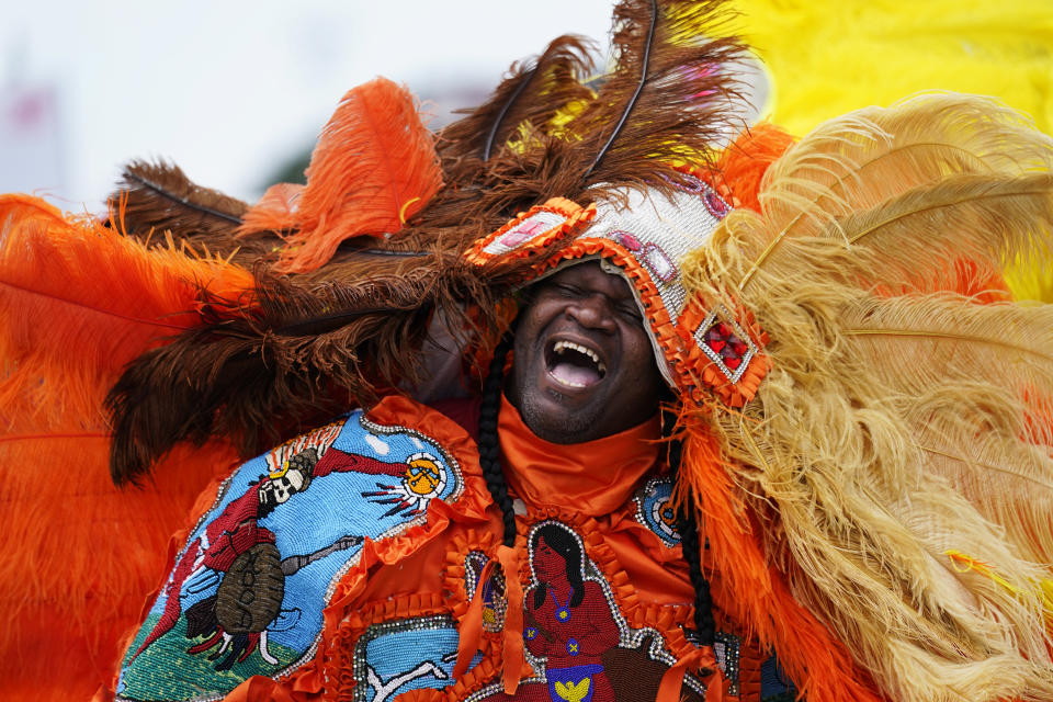 Big Chief Cantrell Watson, of the New Orleans Mardi Gras Indian tribe Wild Mohicans, chants as he parades through the New Orleans Jazz & Heritage Festival in New Orleans, Friday, April 29, 2022. (AP Photo/Gerald Herbert)