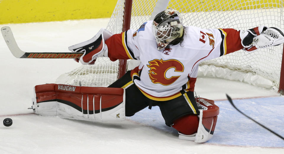 FILE – In this Dec. 17, 2015, file photo, Calgary Flames goalie Karri Ramo (31) deflects a shot during the third period of an NHL hockey game against the Dallas Stars in Dallas. Finland, which has medaled in four of the past five Olympics and has 6-foot-6 Kontinental Hockey League star Mikko Koskinen and longtime NHL goalie Karri Ramo between the pipes. (AP Photo/LM Otero, File)