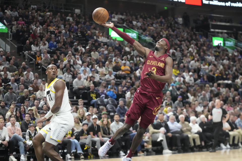 Cleveland Cavaliers guard Caris LeVert (3) goes to the basket as Utah Jazz guard Kris Dunn (11) looks on in the first half of an NBA basketball game Tuesday, April 2, 2024, in Salt Lake City. (AP Photo/Rick Bowmer)
