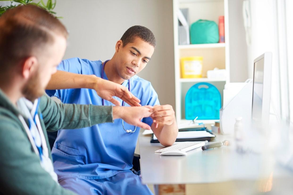 Doctor looking at hand